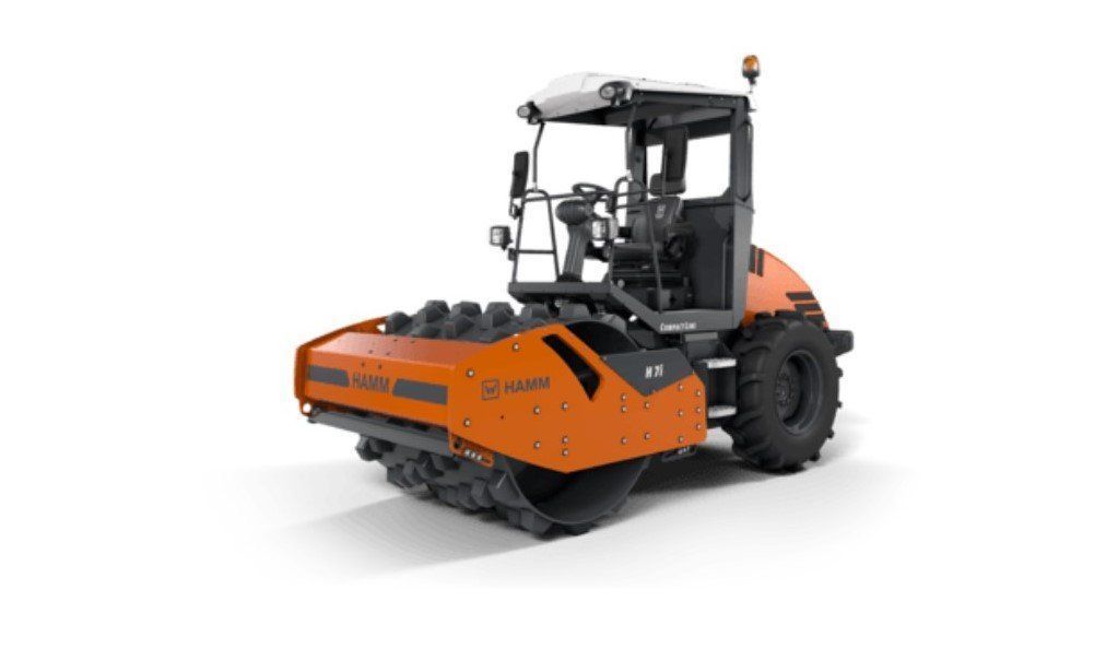 Orange and black HAMM soil compactor machine on a white background.