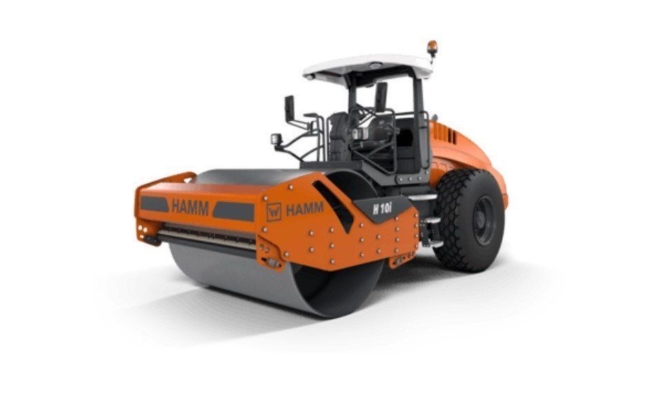 Orange Hamm roller compactor with cabin on white background.