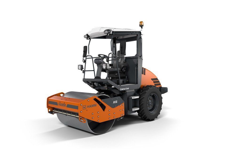 Orange and black road roller on a white background.