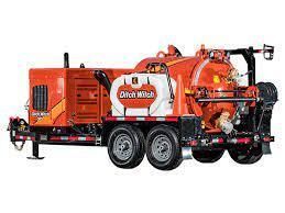 Orange Ditch Witch vacuum excavator trailer with dual wheels, water tank, and vacuum tank.