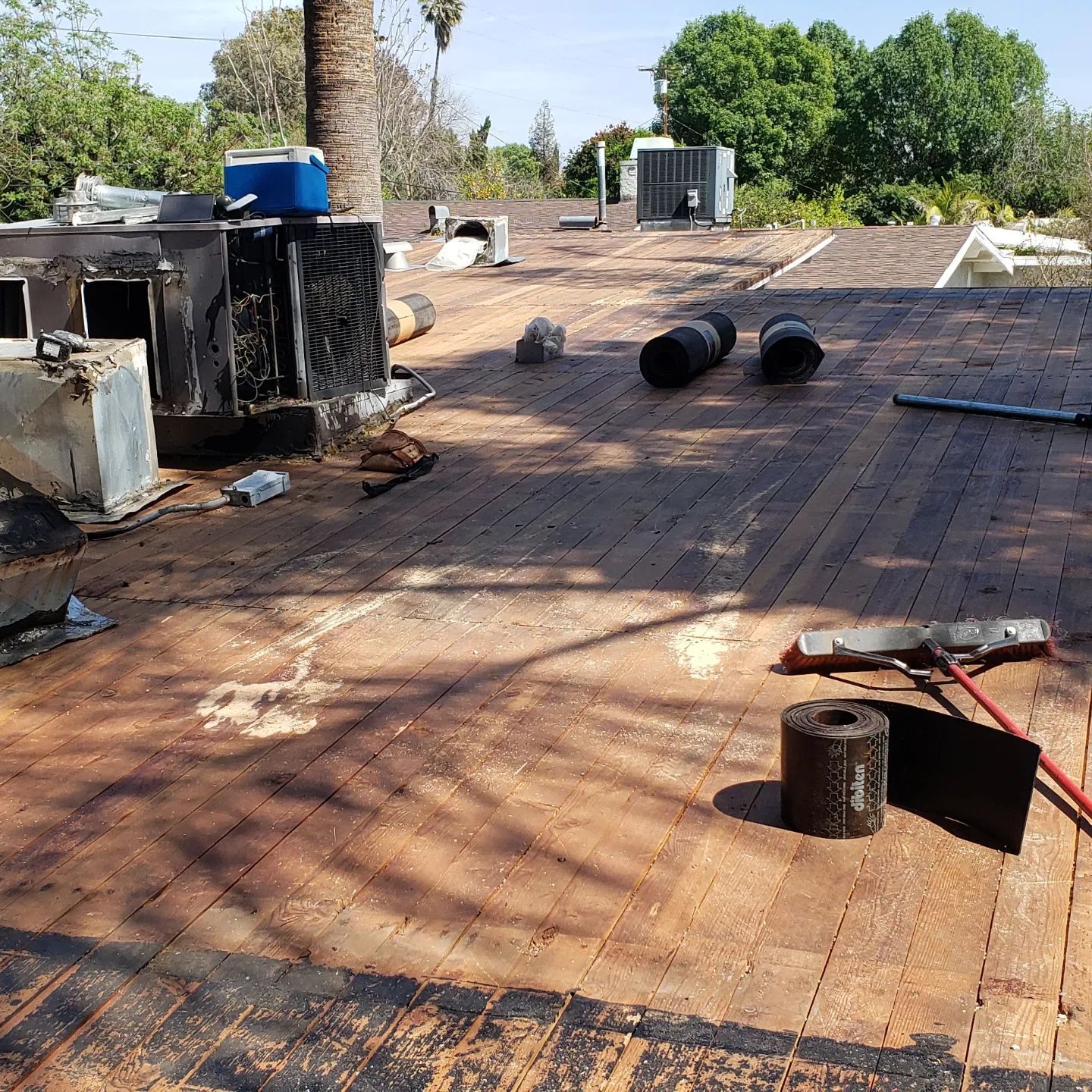 A roof under construction with a chimney in the background