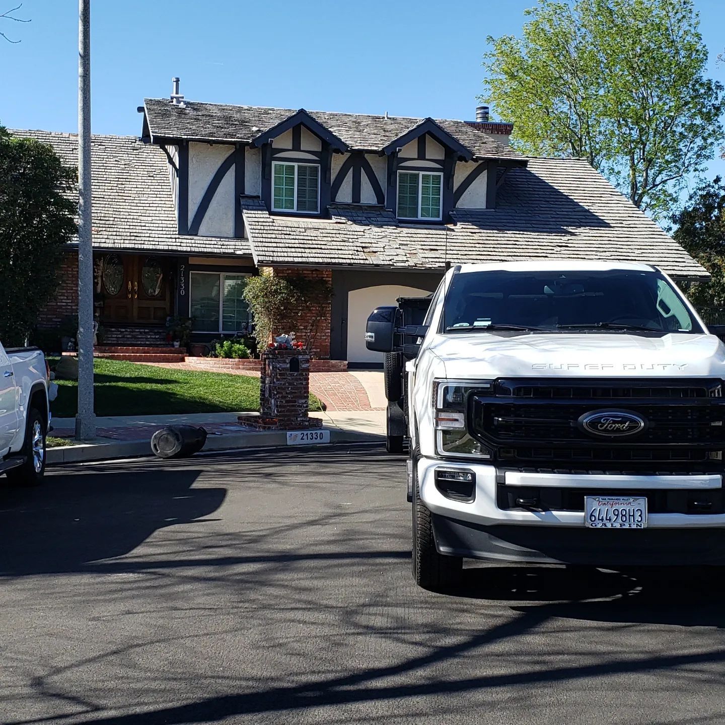 A large wooden box is being lifted into the air by a crane