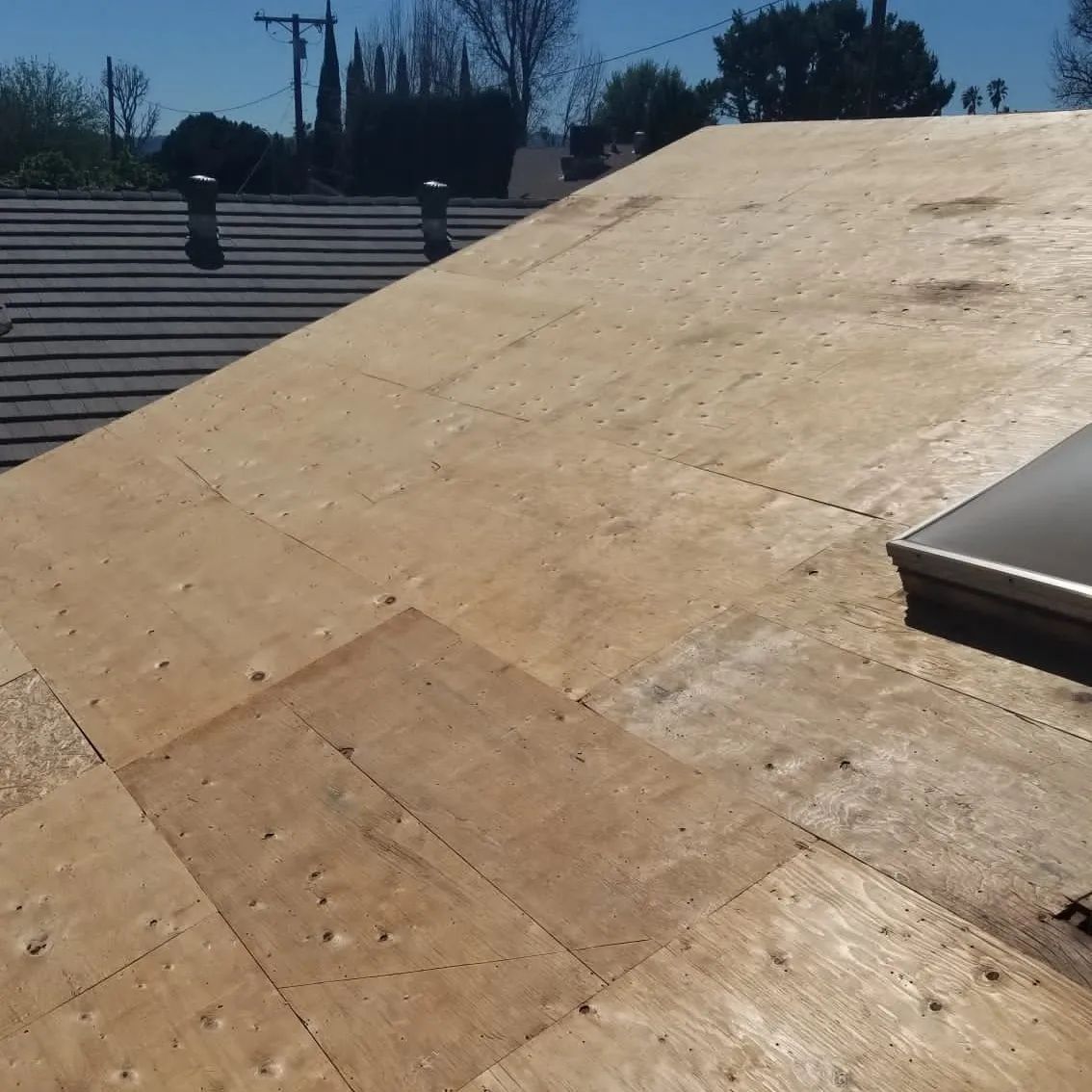 A close up of a wooden roof with nails in it.
