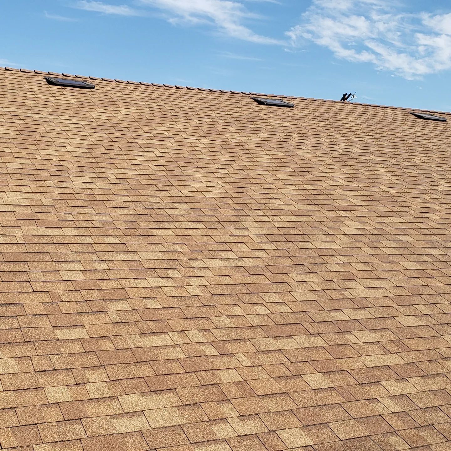 An aerial view of a house with a car parked in front of it