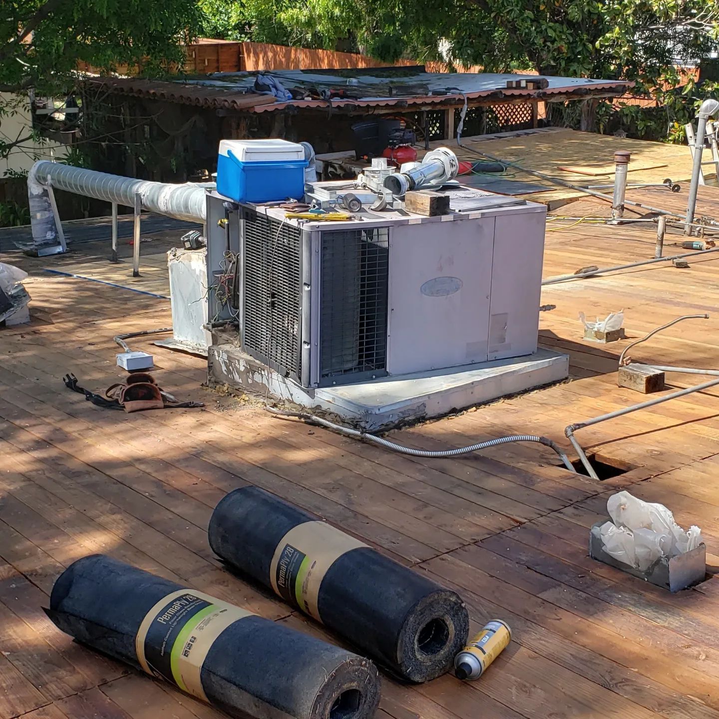 An aerial view of a house with a gray roof and a white roof.