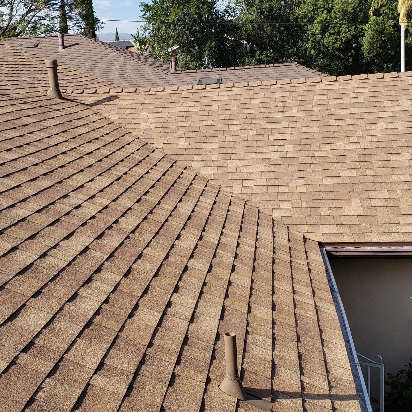 A white roof with a chimney on top of it.