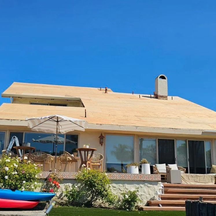 A black roof with a white trim is being installed