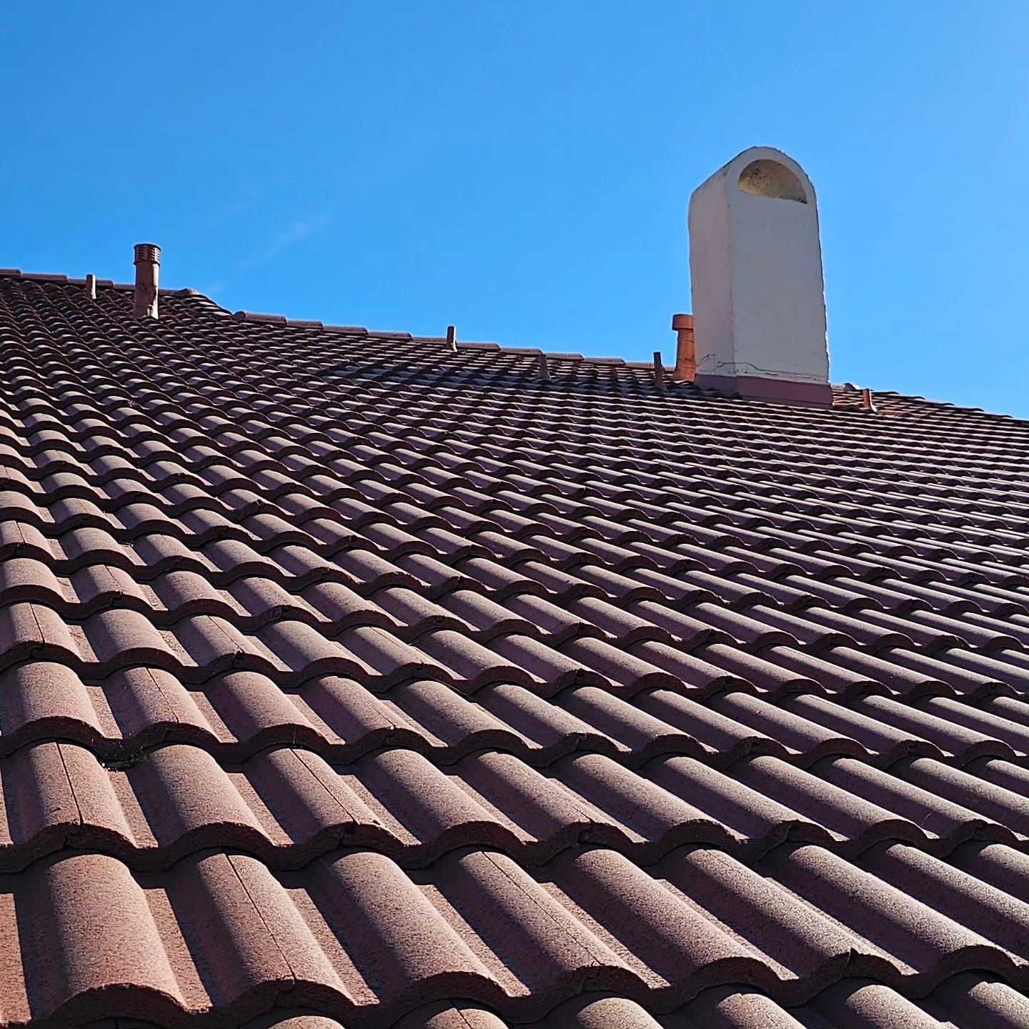 A truck is parked on the roof of a house