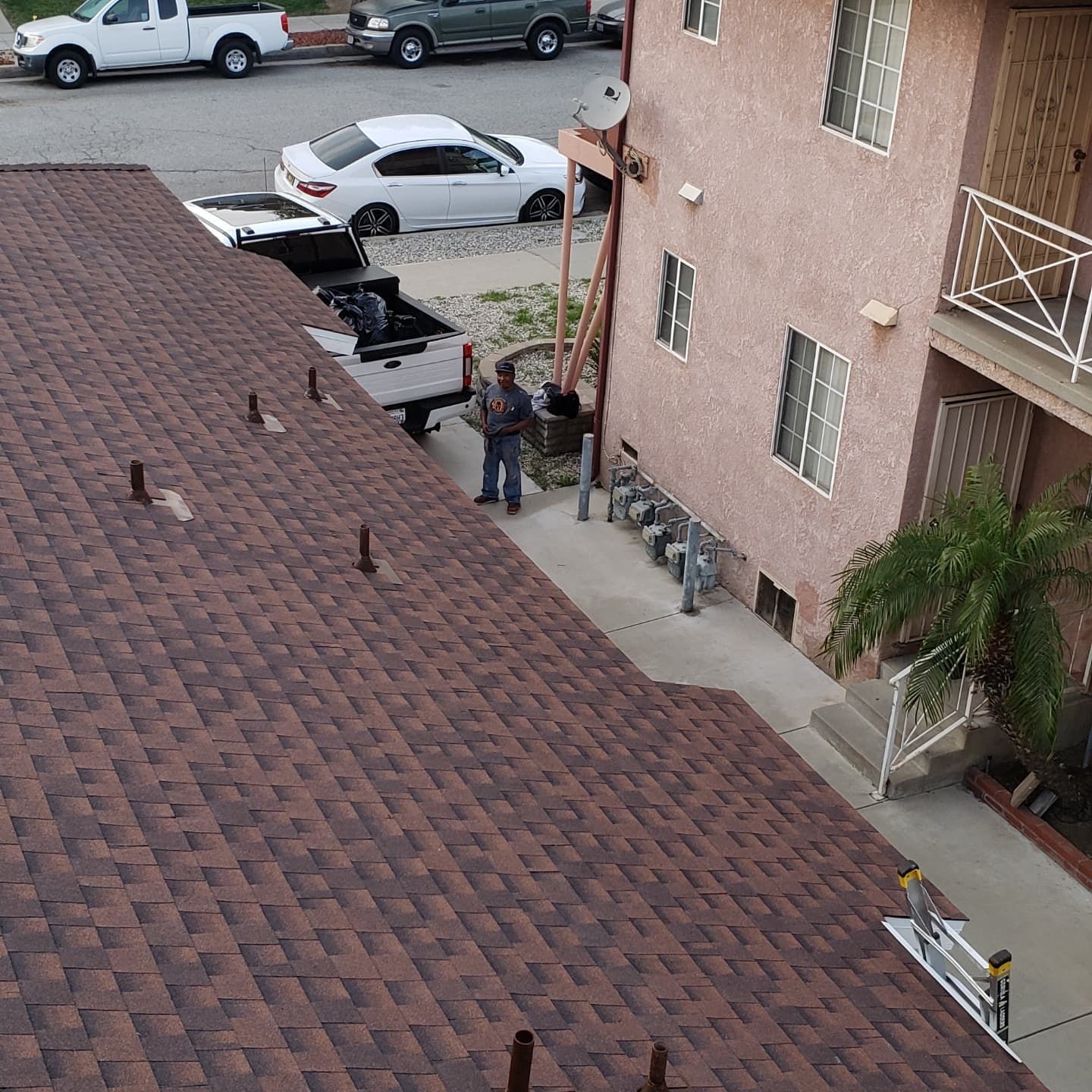 A man is standing on the roof of a building