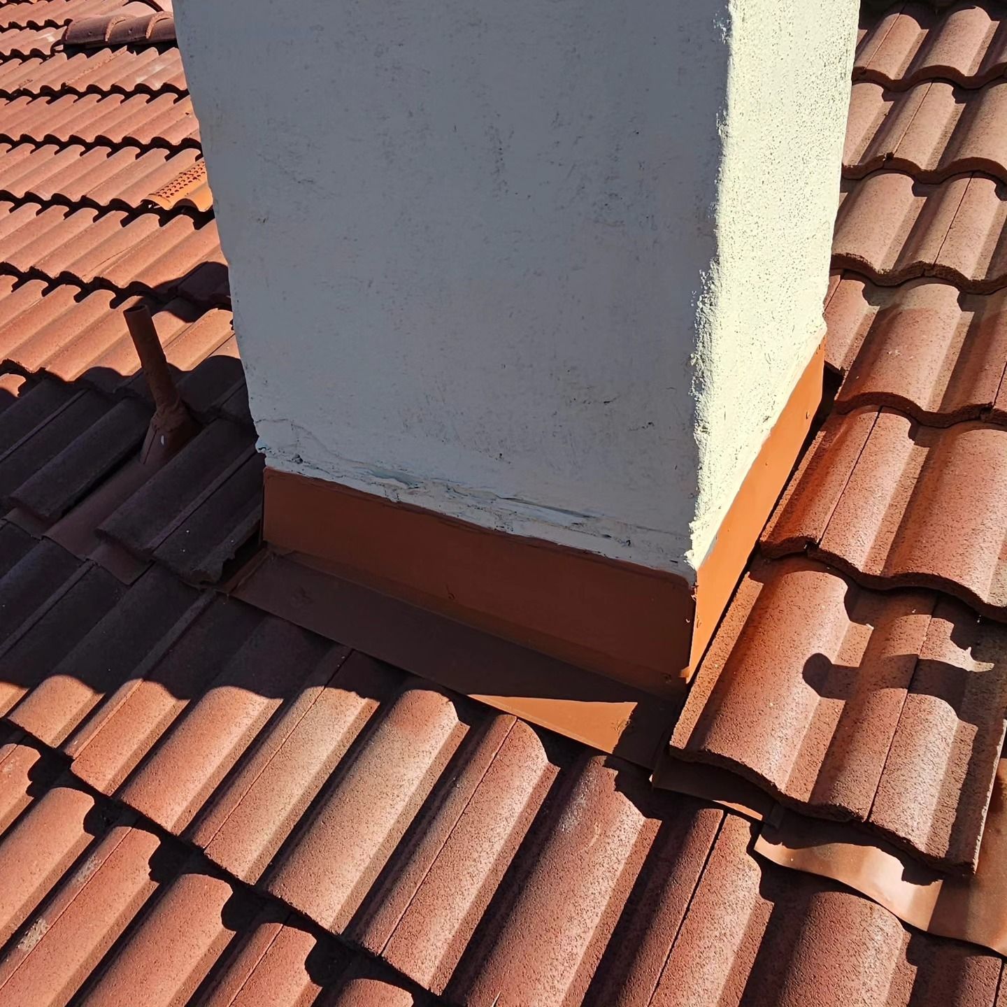 A vacuum cleaner is sitting on top of a wooden roof