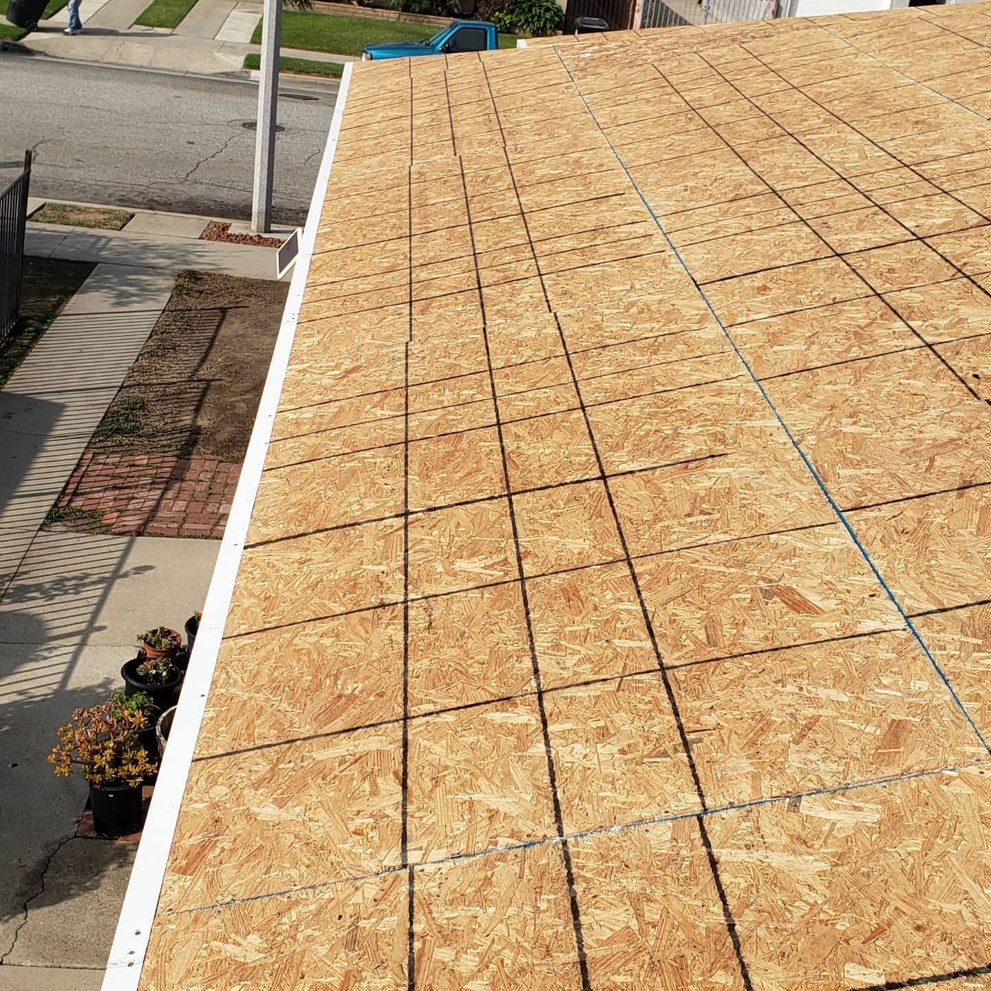 The roof of a house is covered in plywood.
