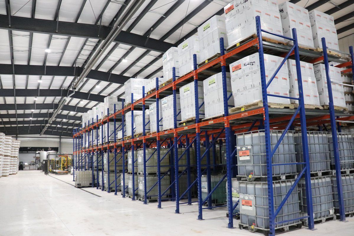 A large warehouse filled with lots of boxes and containers.