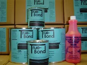 Stacked True-Bond containers with a pink bottle in front on a shelf.