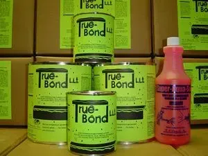 Stacks of green True-Bond cans with a pink bottle on a store shelf.