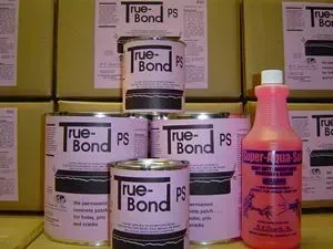 True-Bond PS adhesive cans stacked on a shelf beside a pink bottle.