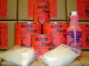 Red boxed dog food with two white bags of powder and a pink bottle on display