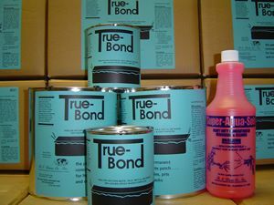 True-Bond adhesive cans and a pink bottle displayed on shelves in a warehouse setting