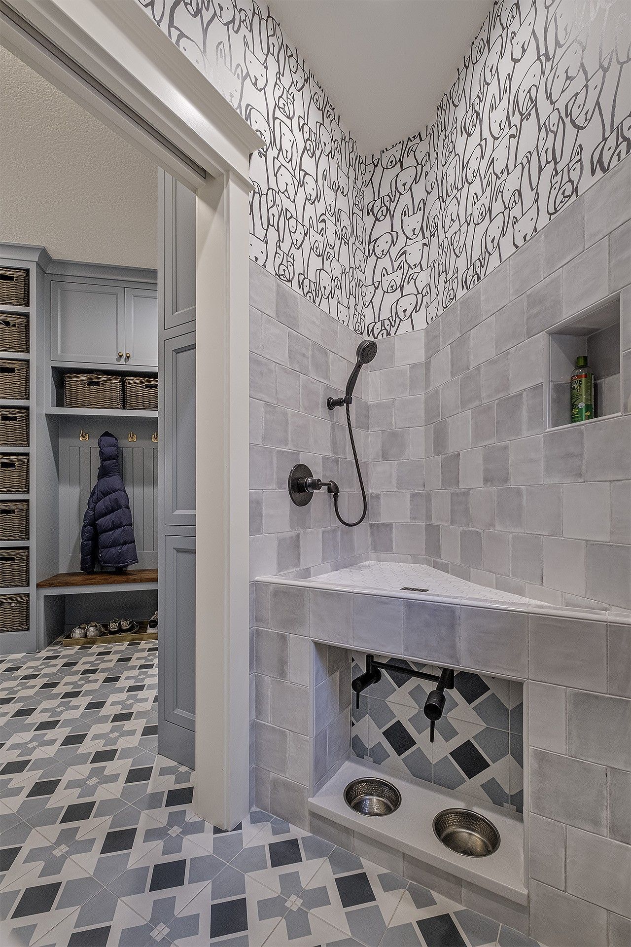 A dog shower and two dog bowls.