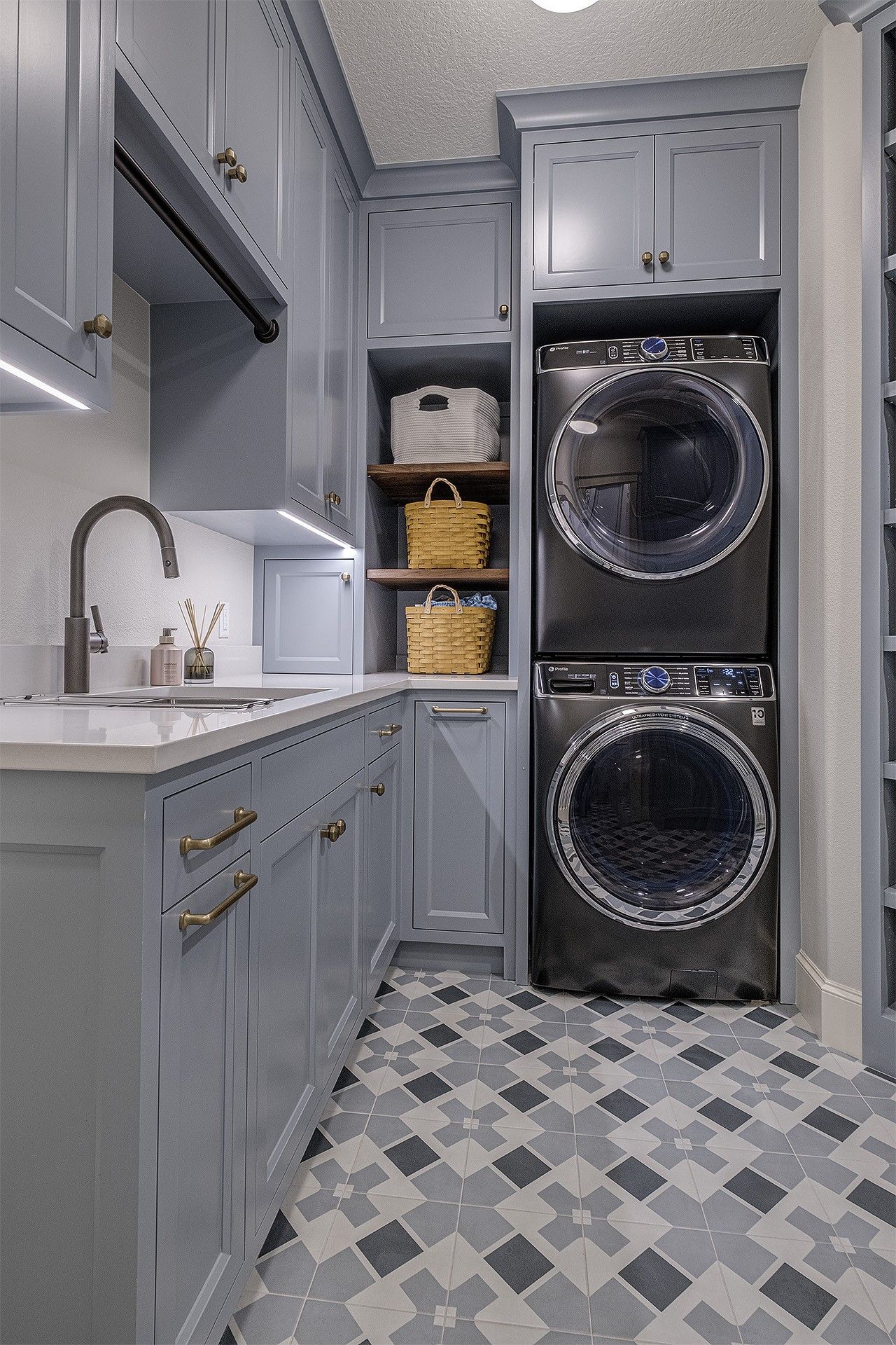 A laundry room with a washer and dryer stacked on top of each other.