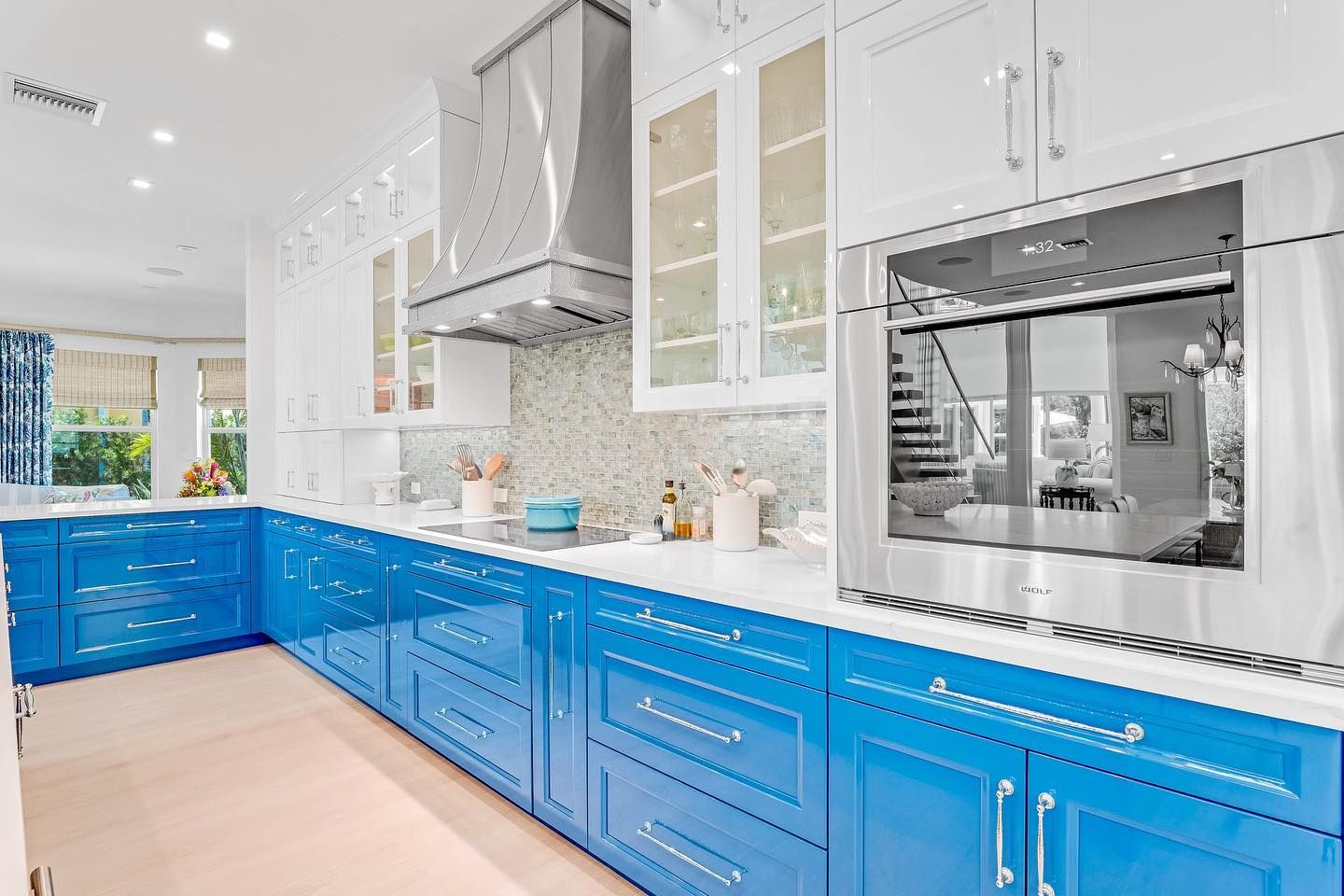 Bright blue and white kitchen with stainless steel appliances.