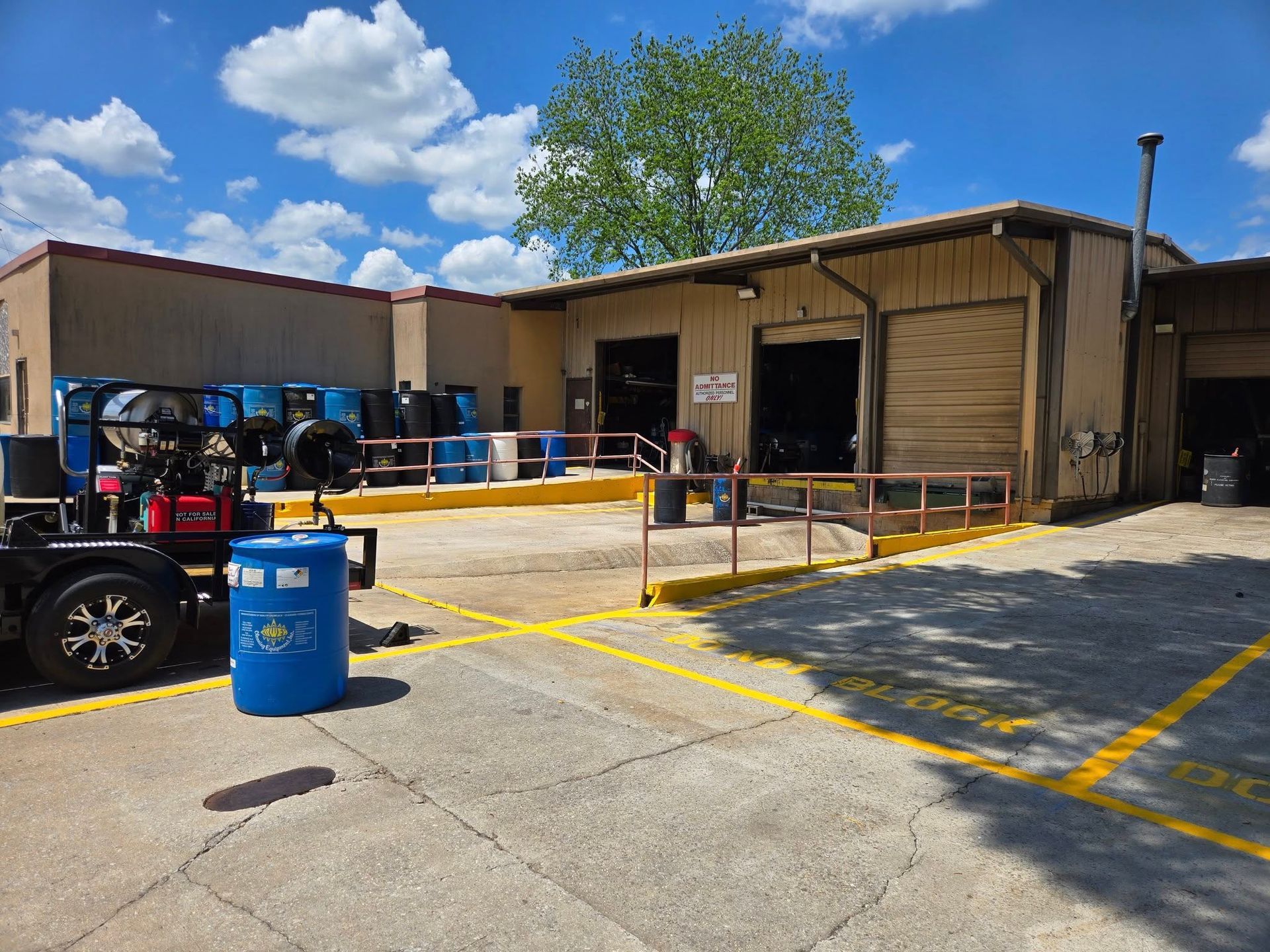 A large building with a lot of barrels in front of it.