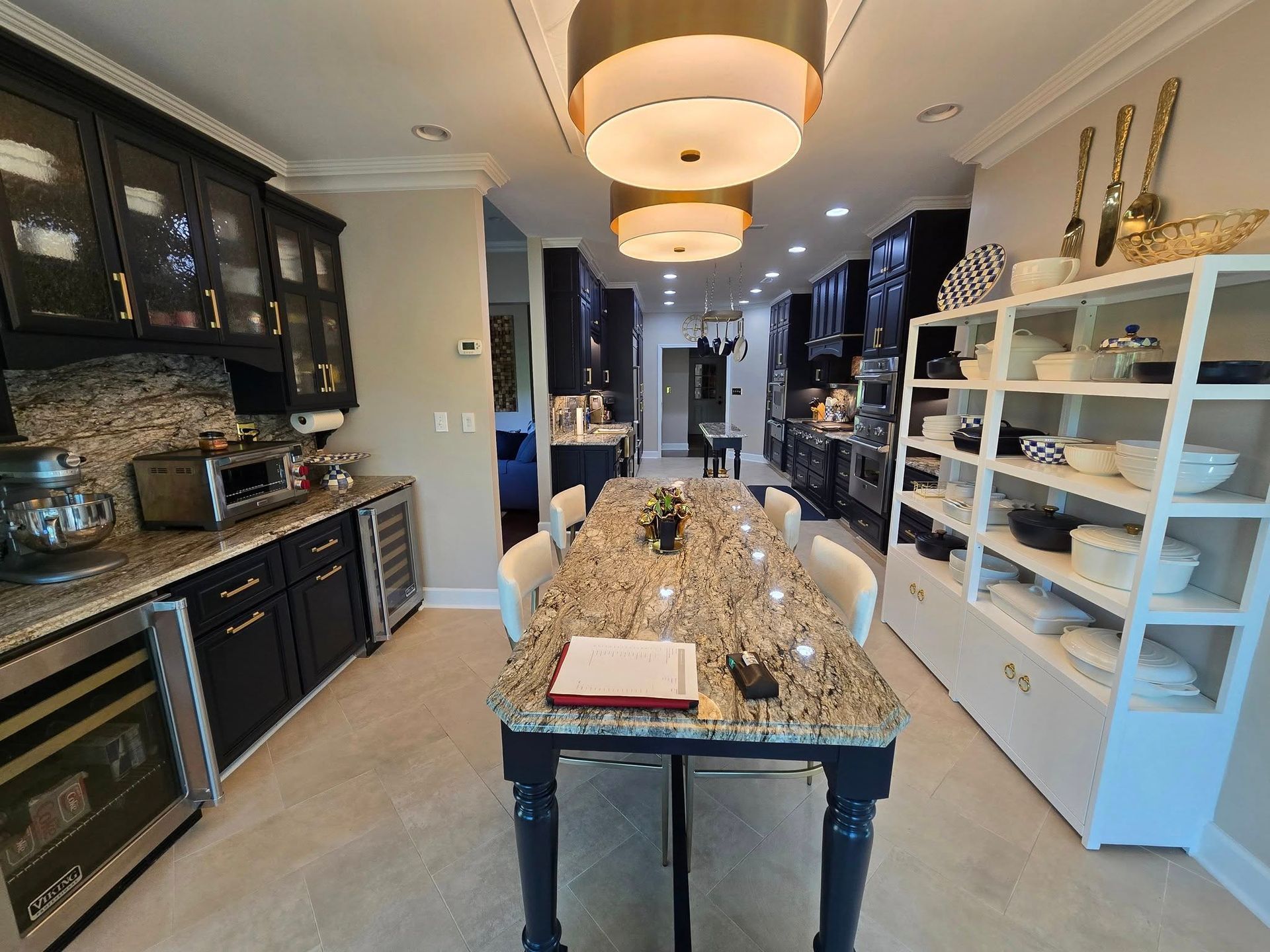 A kitchen with a large table and a book on the counter.