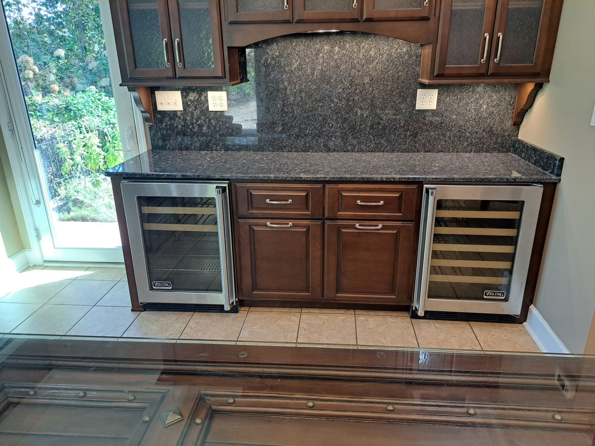 A kitchen with stainless steel appliances and wooden cabinets.