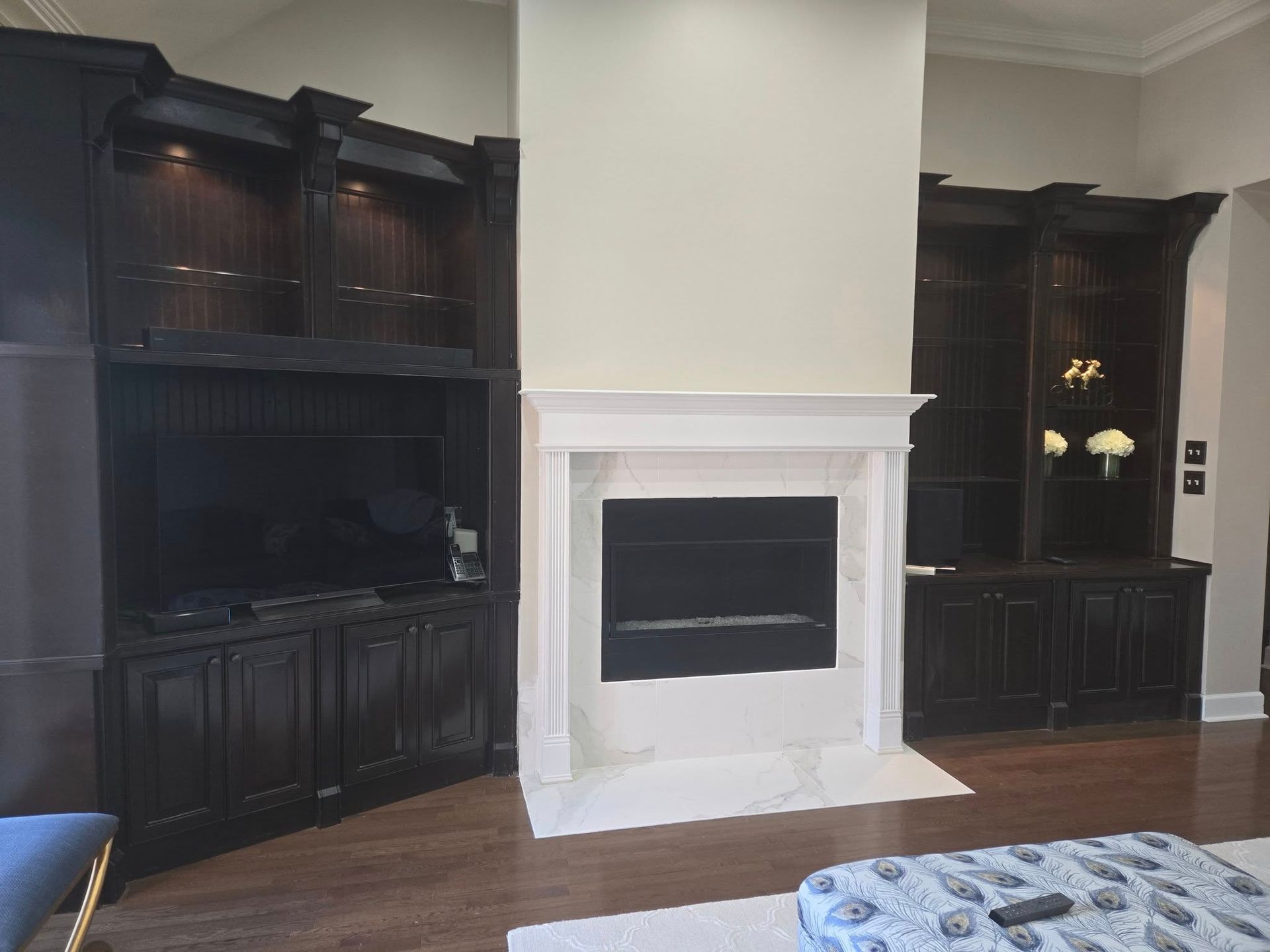 A living room with a fireplace and a flat screen tv