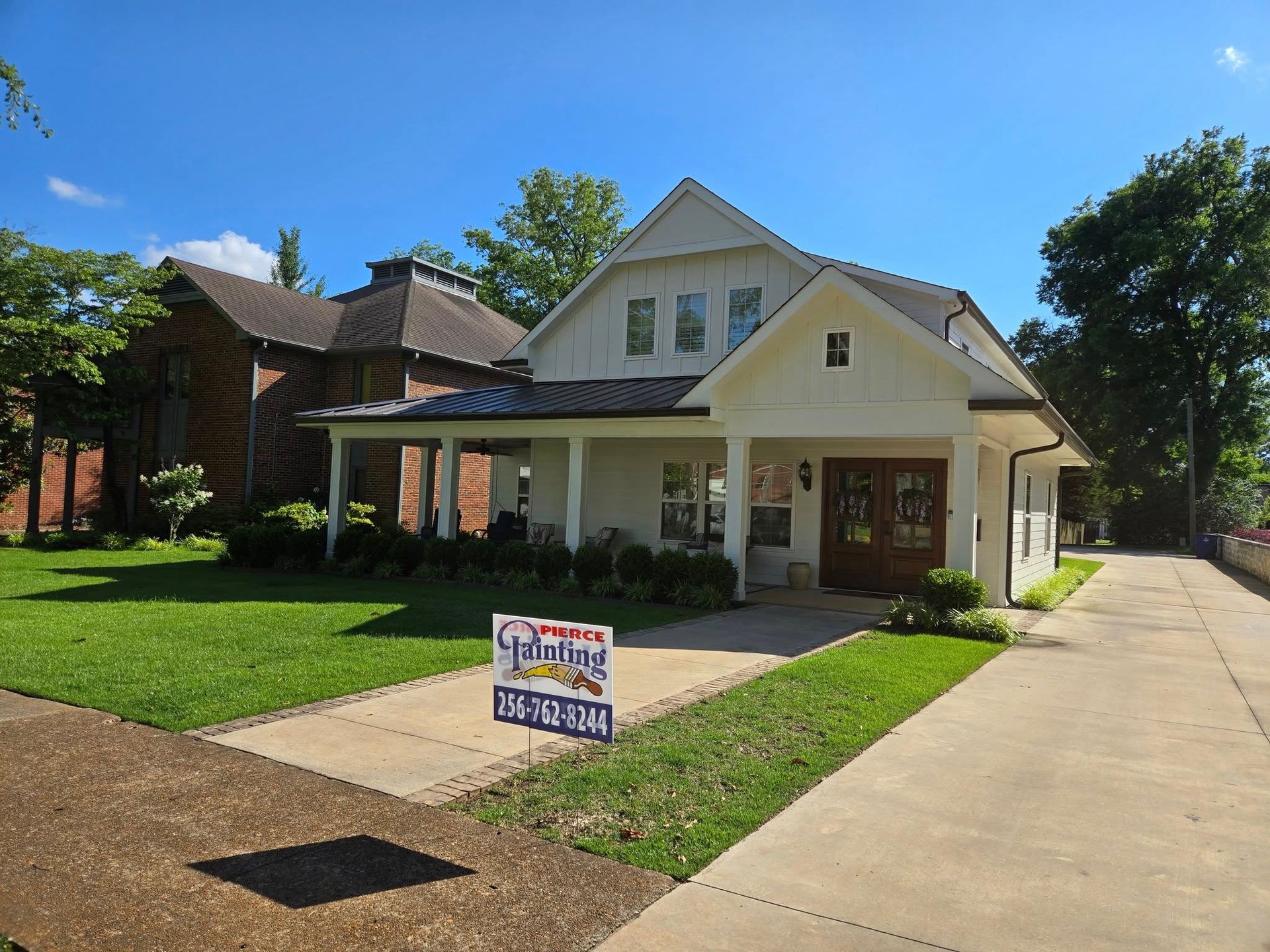 A white house with a for sale sign in front of it