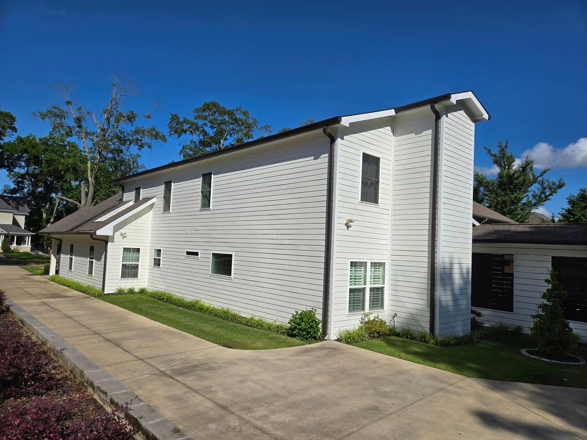 A white house with a driveway leading to it