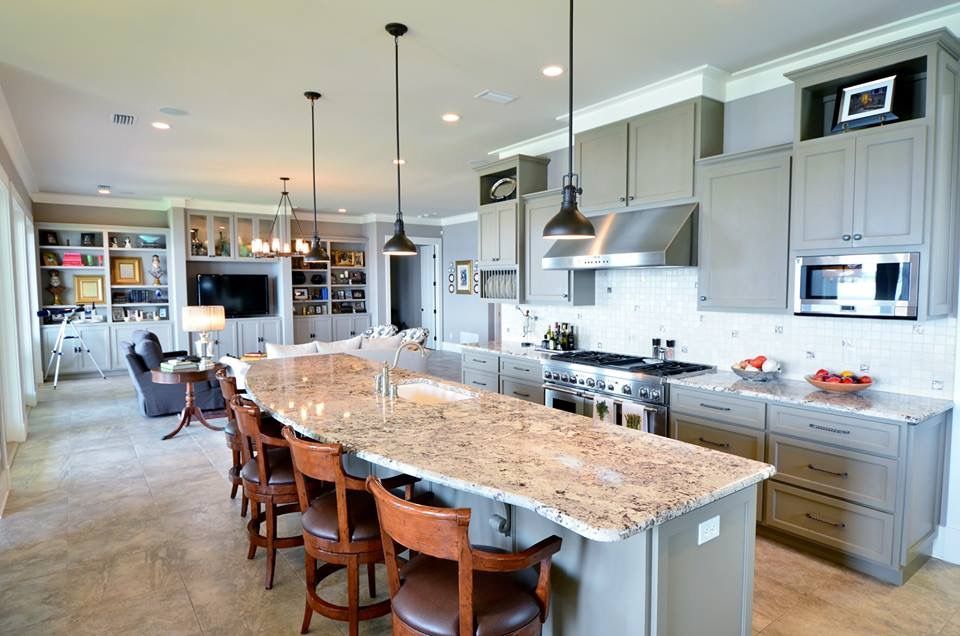 a large kitchen with granite counter tops and stainless steel appliances .