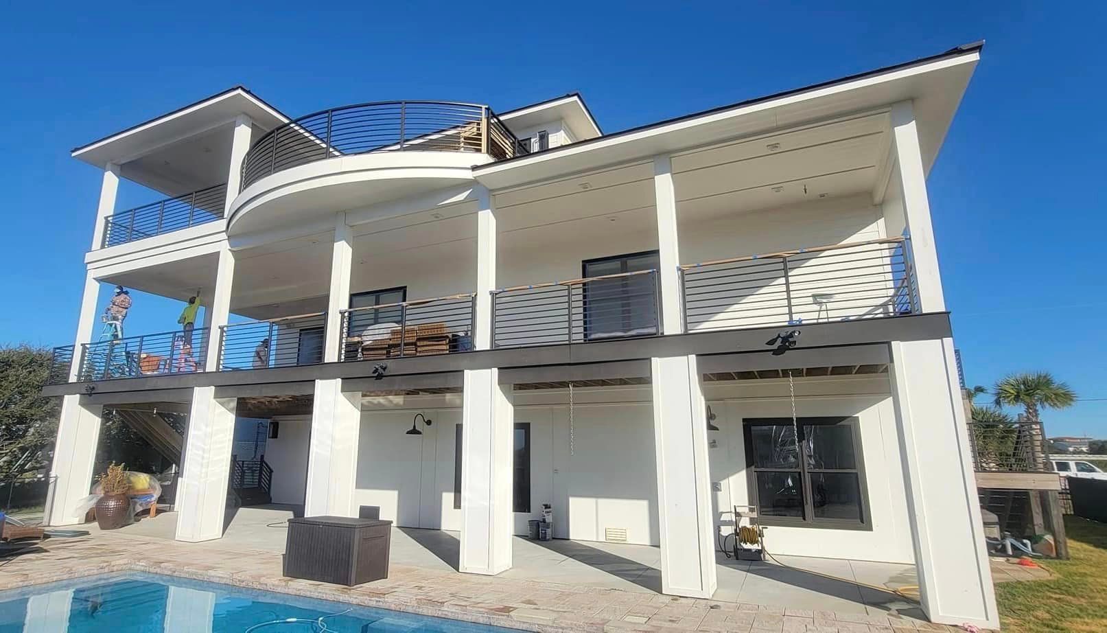 a large white house with a swimming pool in front of it .