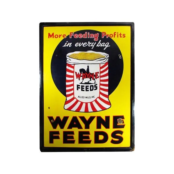 Vintage Wayne Feeds sign with a feed bag illustration on a yellow and black background.