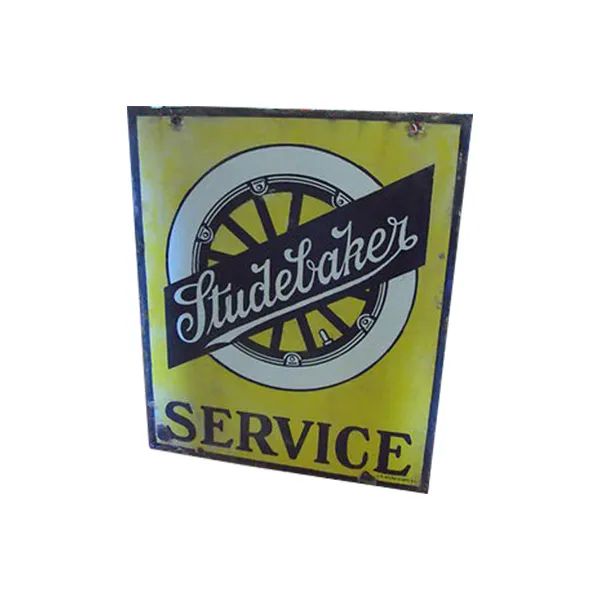 Yellow Studebaker service sign with black lettering and wheel logo