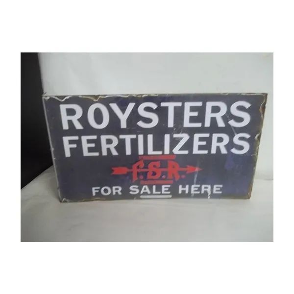 Vintage ROYSTERS FERTILIZERS for sale sign on a dark background