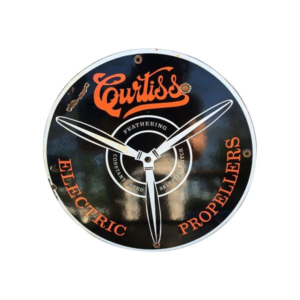 Curiss Electric Propellers vintage round sign with black background, orange lettering, and silver propeller graphic