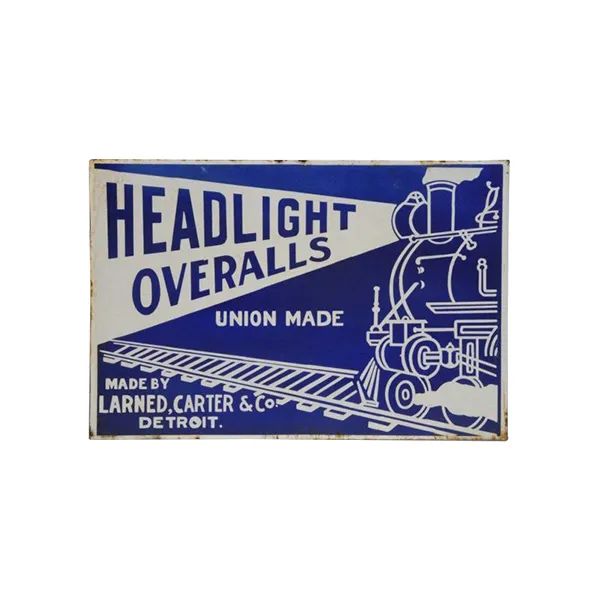 Blue vintage sign reading “HEADLIGHT OVERALLS” with truck illustration and “Union Made” text.