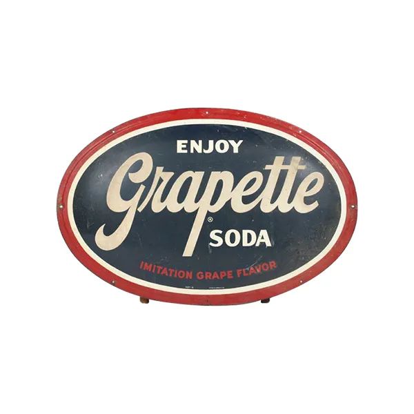 Vintage oval Grapette Soda sign in red, navy, and cream with “Enjoy Grapette Soda” text