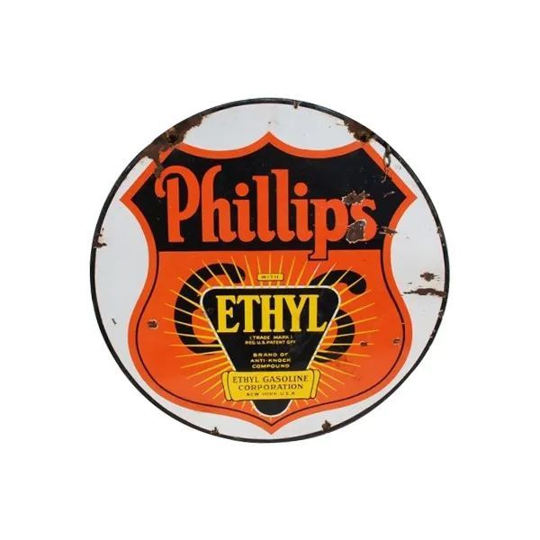 Round vintage Phillips Ethyl gasoline sign in orange, black, and yellow.