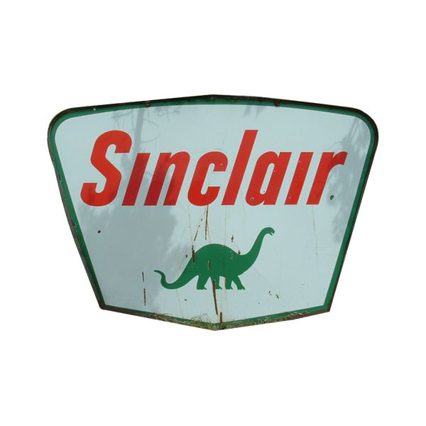 Vintage Sinclair sign with red text and green dinosaur logo on a pale background