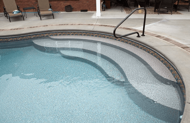 A view of a pool with stairs