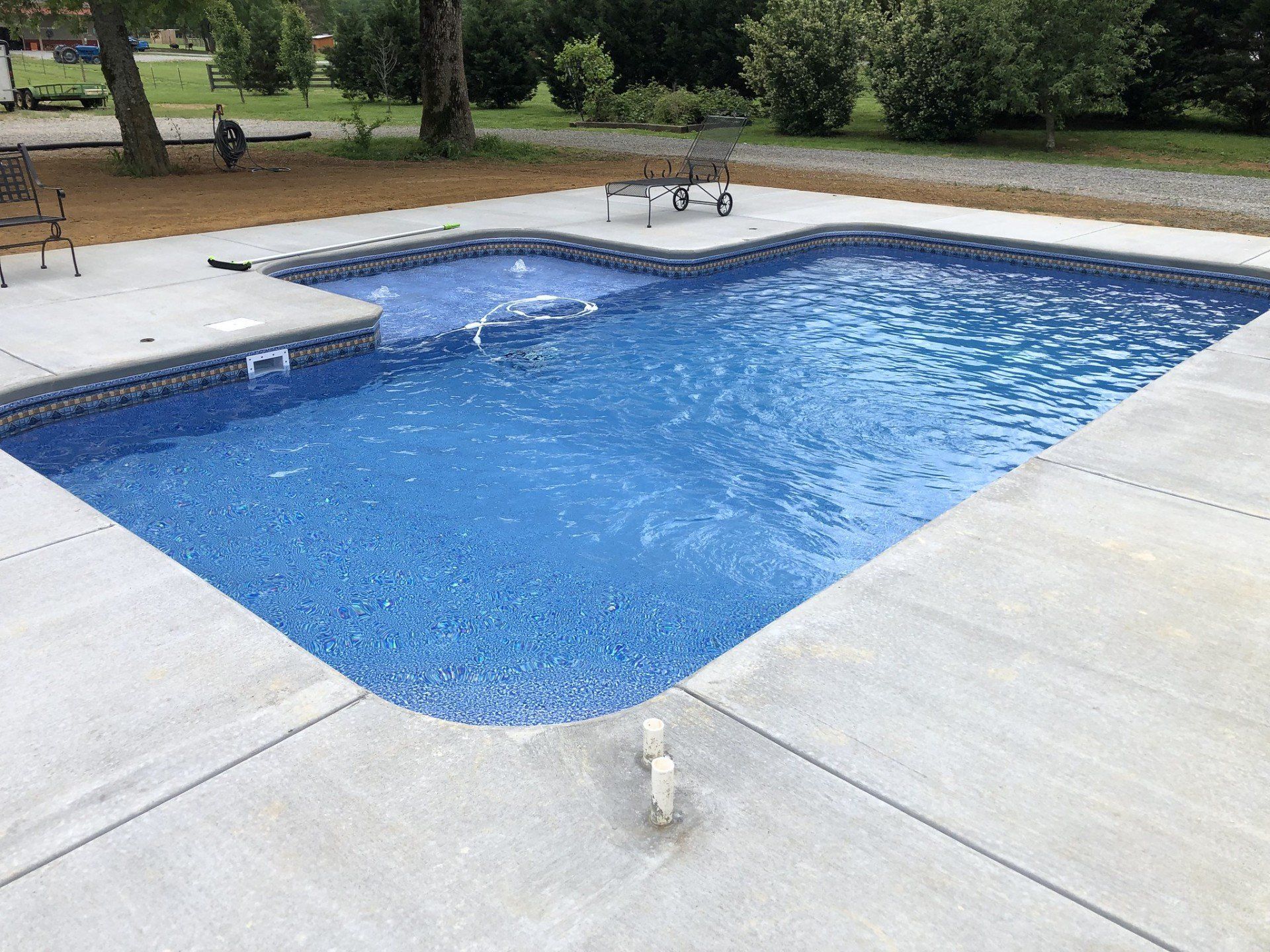 A view of a pool and garden