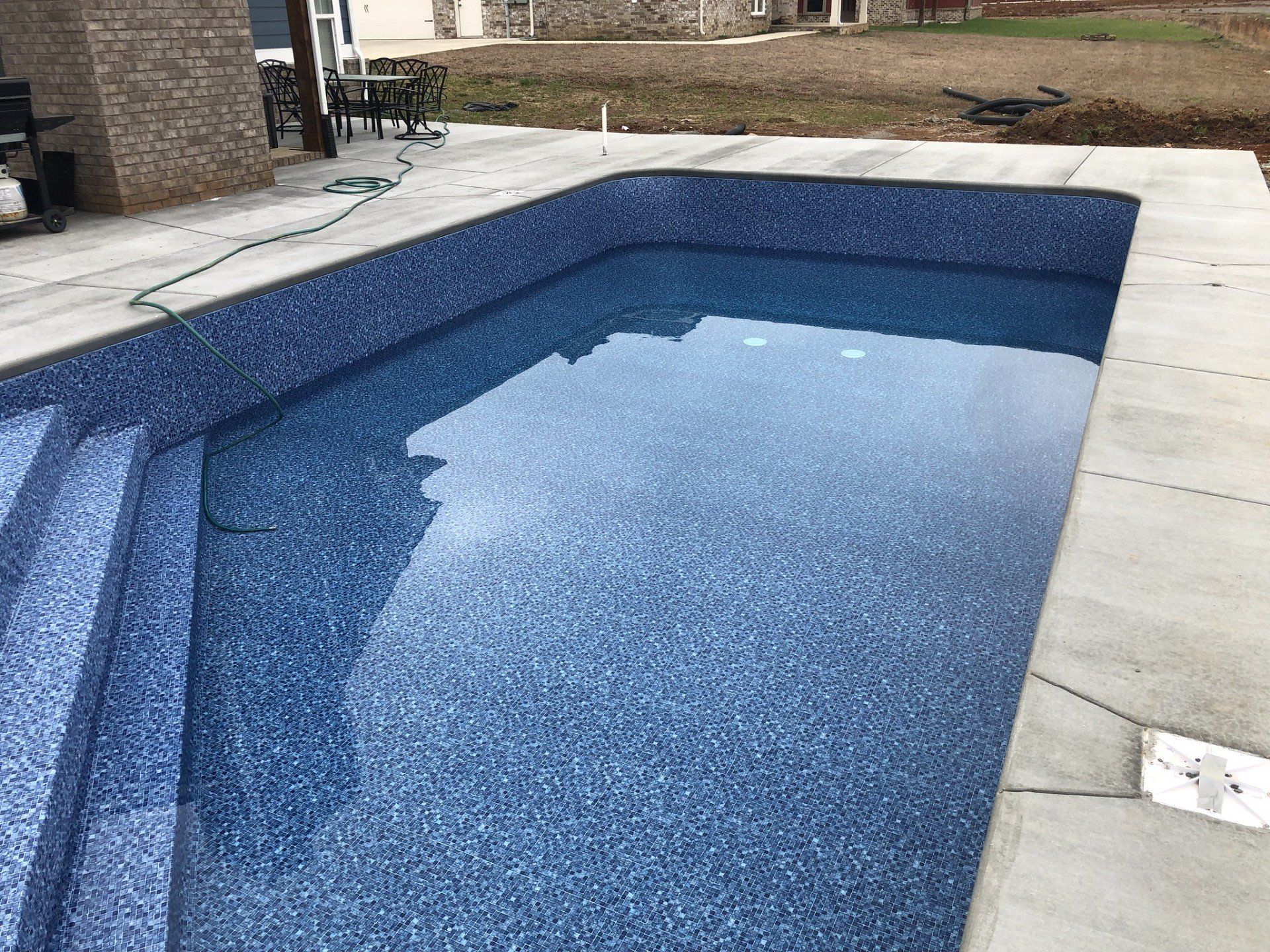 A modern pool with mosaic tiles