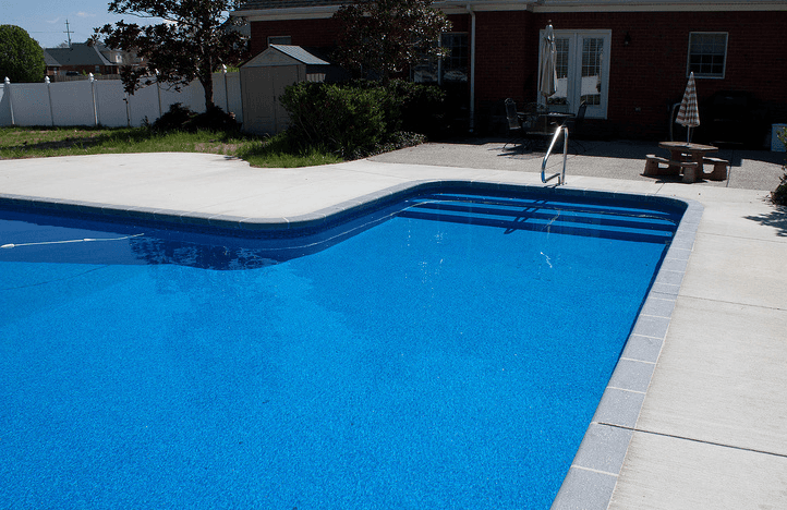 A swimming pool with modern house at the back