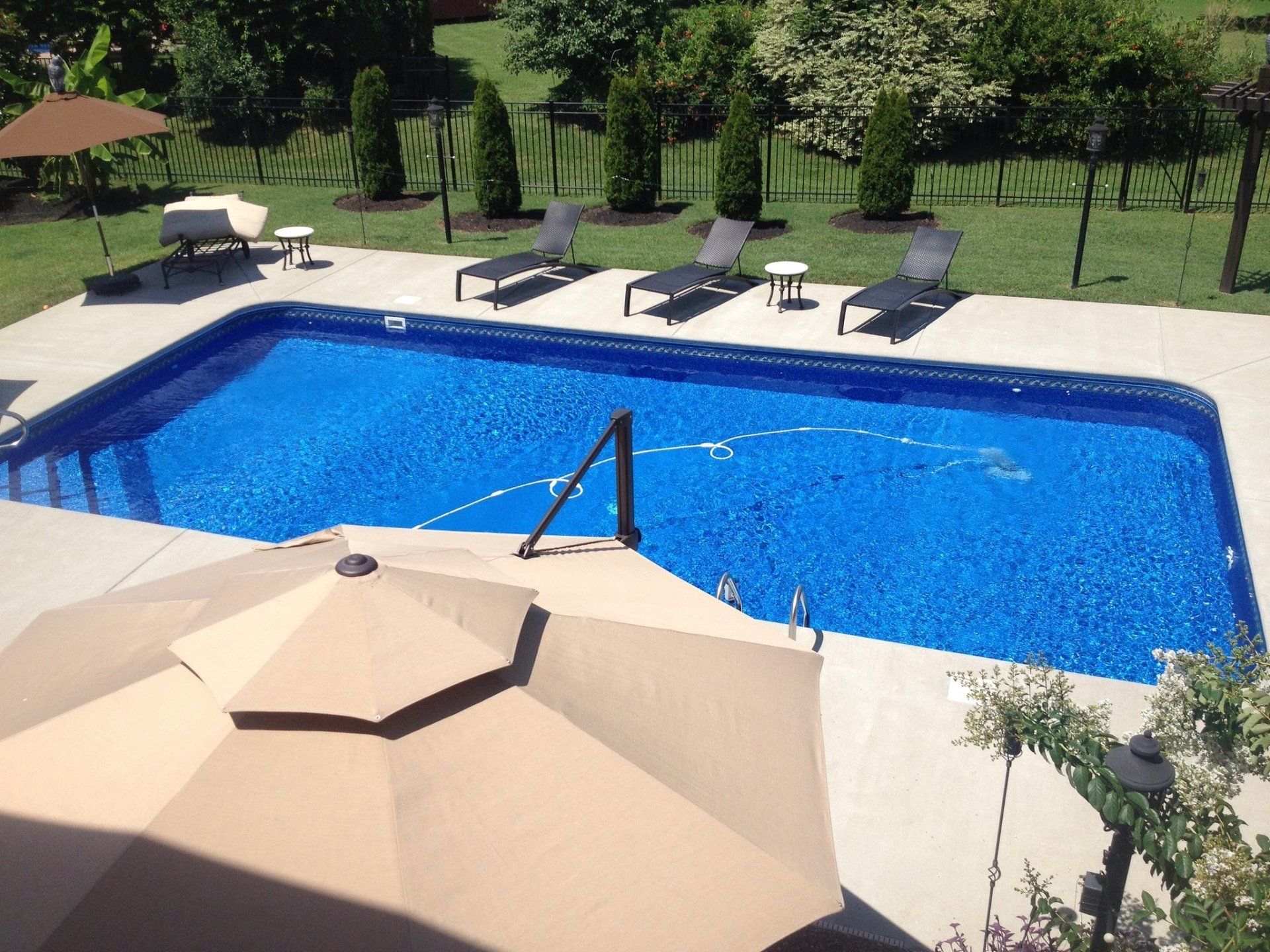 A pool with outside furniture and deck