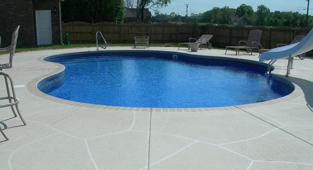 A pool with outside furniture