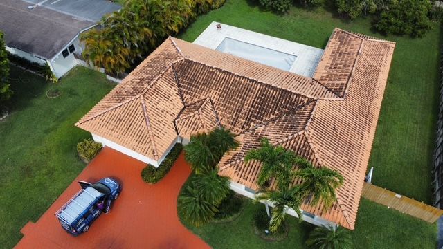 An aerial view of a house with a car parked in front of it.
