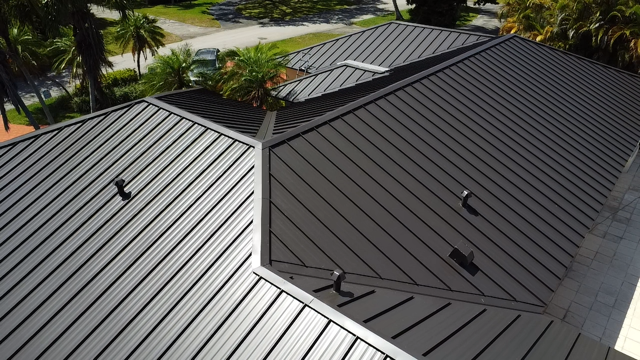 An aerial view of a black metal roof on a house.