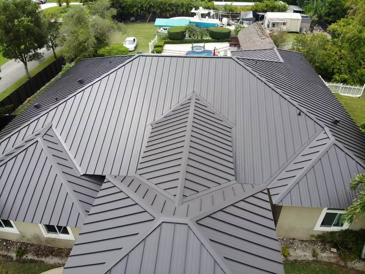 An aerial view of a house with a metal roof.