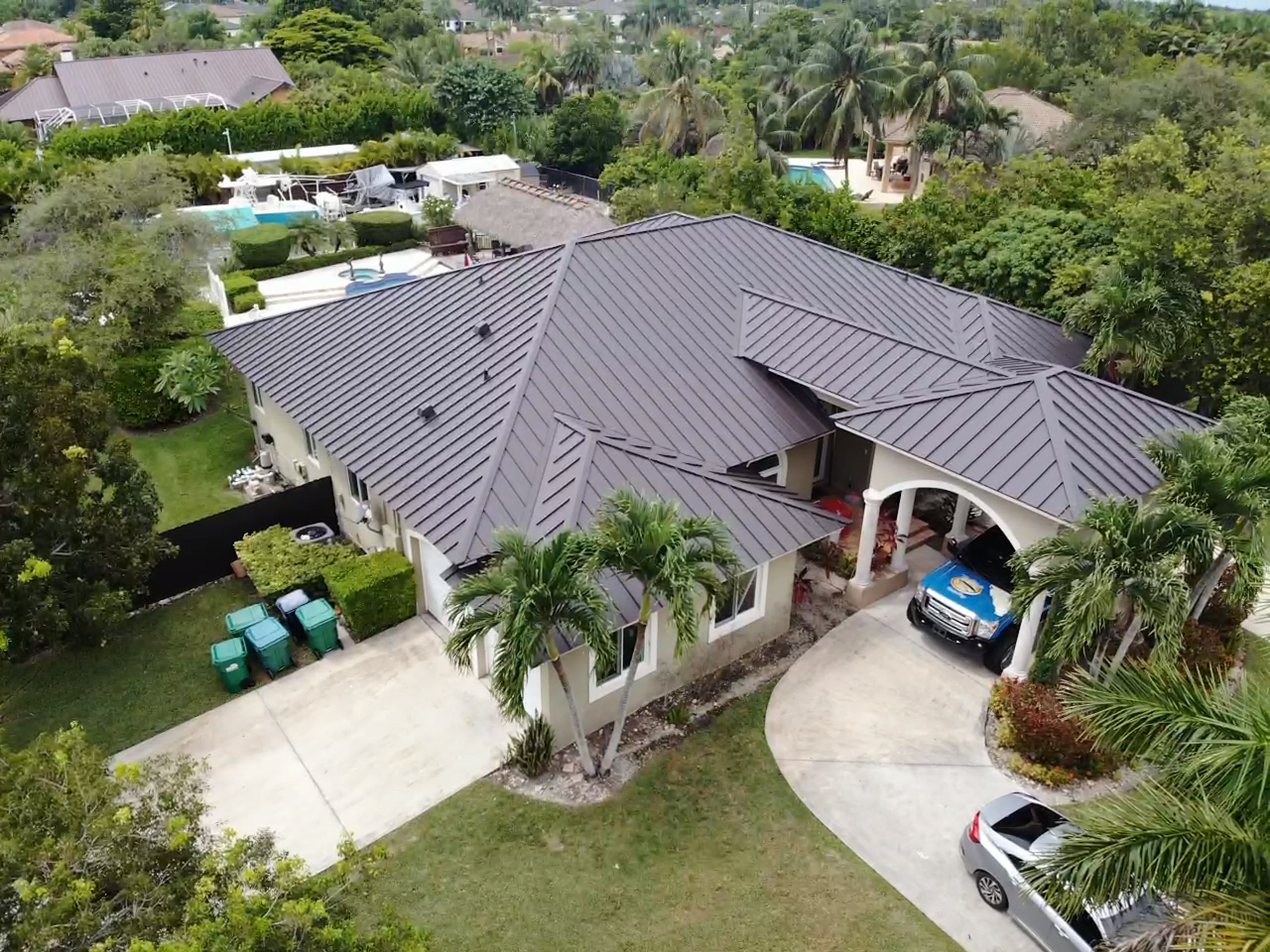 An aerial view of a house with a car parked in front of it.